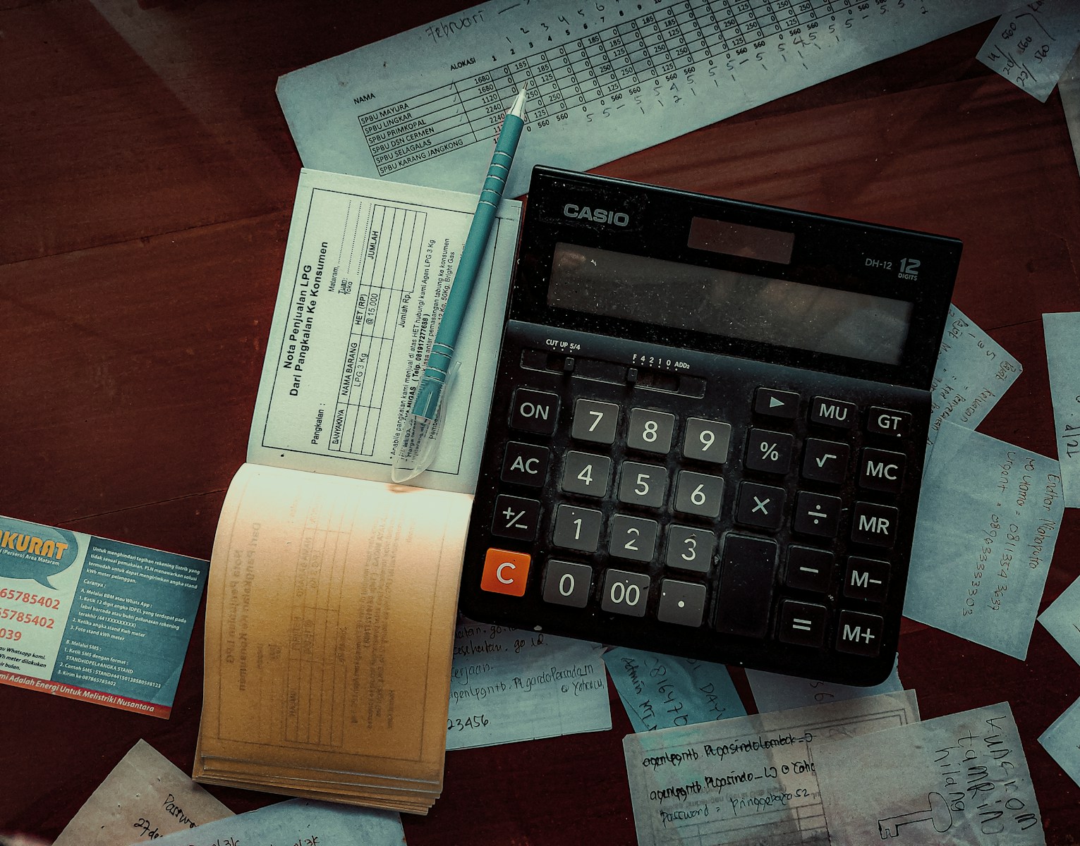 a calculator sitting on top of a wooden table to help you calculate the right amount of business insurance with your budget